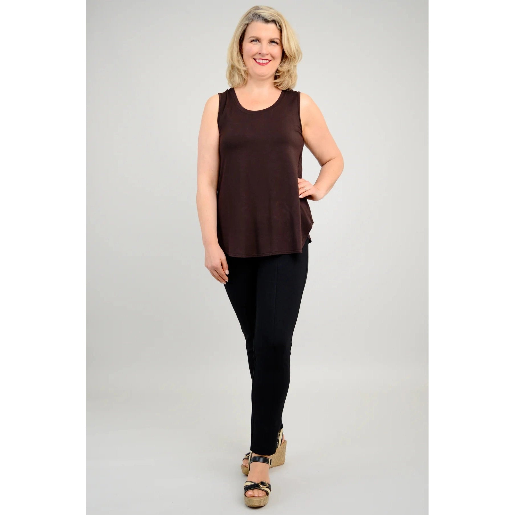 Blue Sky Jazz Tank in Coffee shown on a model wearing black leggings, against a white background, from the front view. 