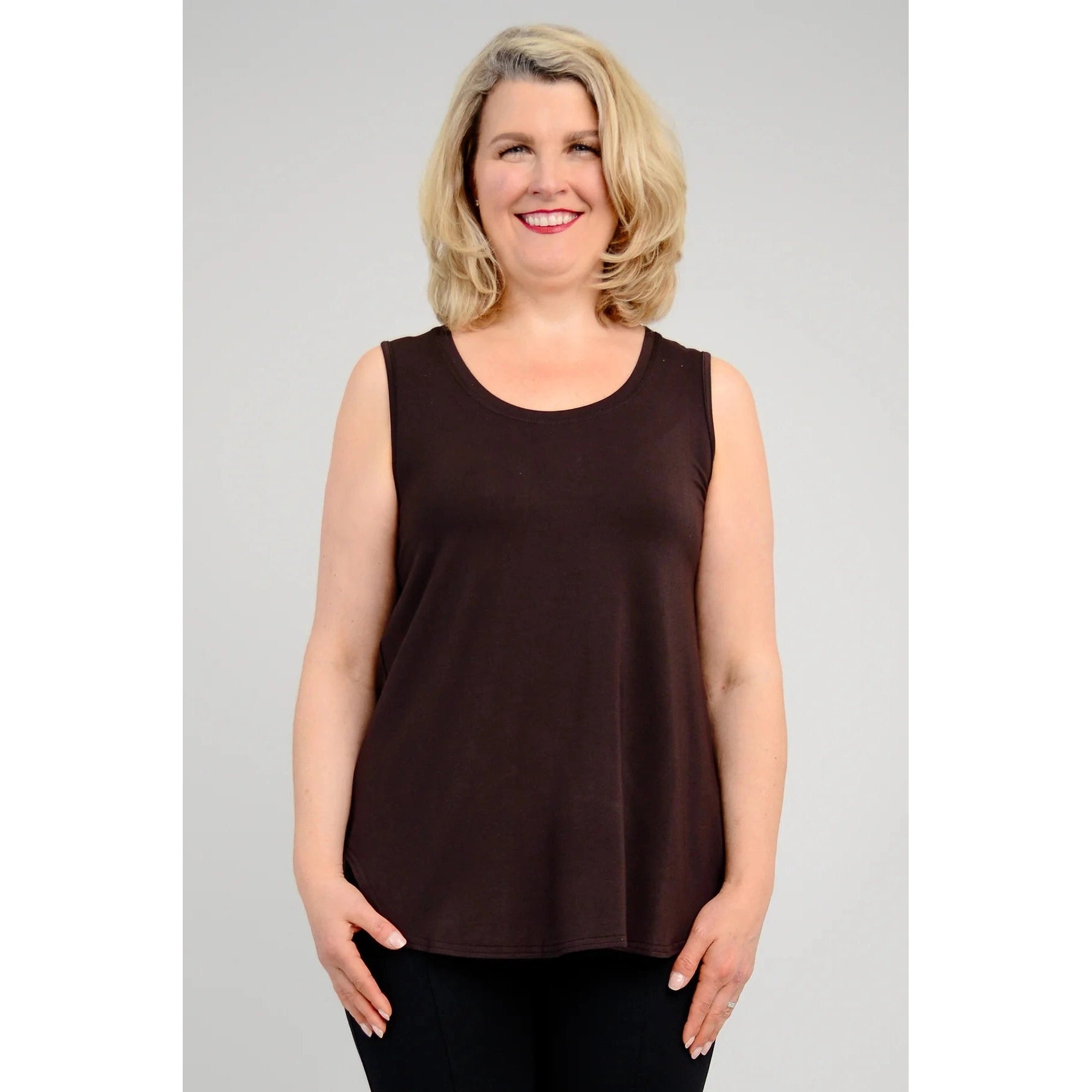 Blue Sky Jazz Tank in Coffee shown on a model wearing black leggings, against a white background, from the front view. 