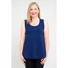 Blue Sky Jazz Tank in Indigo shown on a model wearing black leggings standing against a white background, from the front view. 