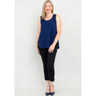 Blue Sky Jazz Tank in Indigo shown on a model wearing black leggings standing against a white background, from the front view. 