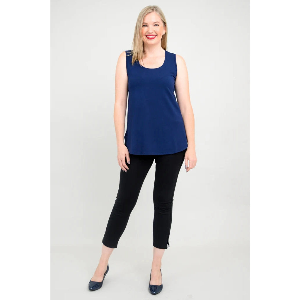 Blue Sky Jazz Tank in Indigo shown on a model wearing black leggings standing against a white background, from the front view. 