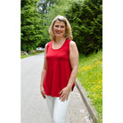 Blue Sky Jazz Tank in Lipstick Red shown on a model wearing black leggings against a white background, from the front view. 