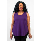 Blue Sky Jazz Tank in Royale Purple shown on a model wearing black leggings standing against a white background, from the front view. 