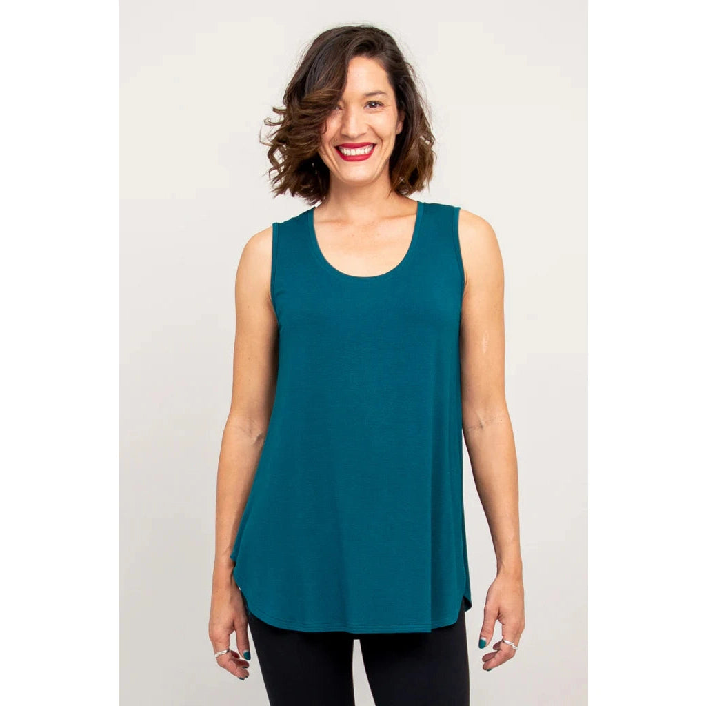 Blue Sky Jazz Tank in Teal shown on a model wearing black leggings against a white background, from the front view. 