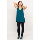 Blue Sky Jazz Tank in Teal shown on a model wearing black leggings against a white background, from the front view. 
