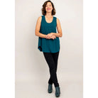Blue Sky Jazz Tank in Teal shown on a model wearing black leggings against a white background, from the front view. 