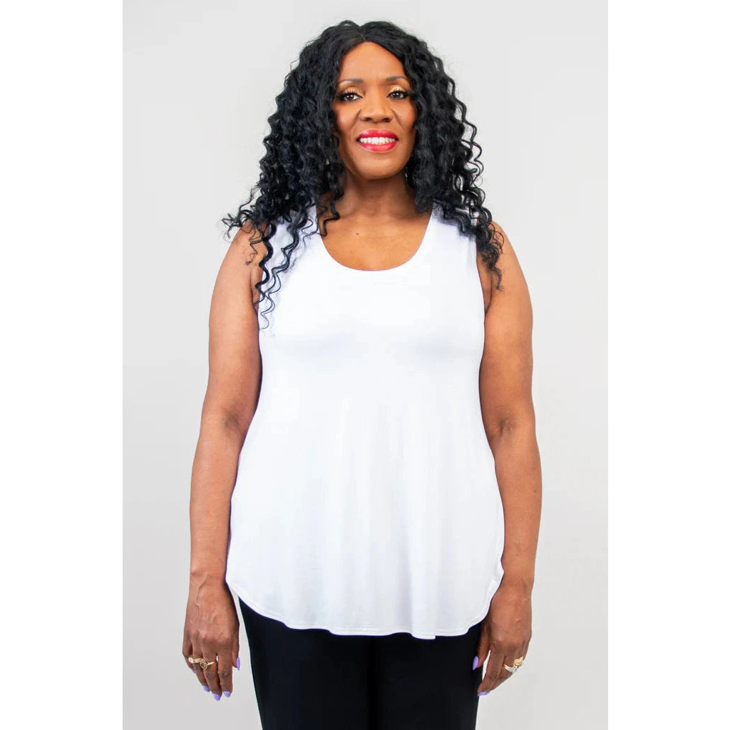 Blue Sky Jazz Tank in White shown on a model wearing black leggings standing against a white background, from the front view. 