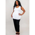 Blue Sky Jazz Tank in White shown on a model wearing black leggings standing against a white background, from the front view. 