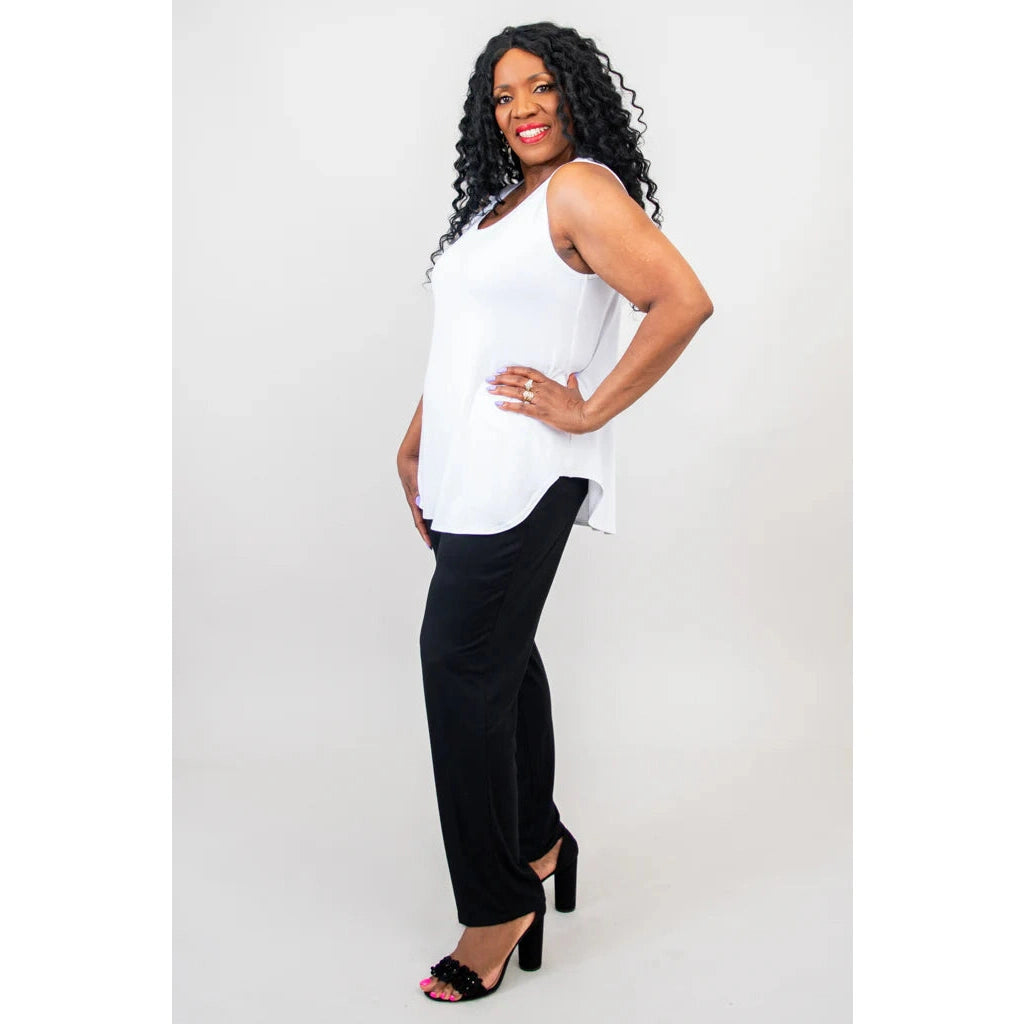Blue Sky Jazz Tank in White shown on a model wearing black leggings standing against a white background, from the front view. 