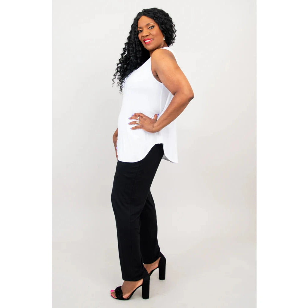 Blue Sky Jazz Tank in White shown on a model wearing black leggings standing against a white background, from the side view. 