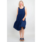 Blue Sky Juni Dress in Indigo shown on a model against a white background, from the front view. 