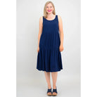 Blue Sky Juni Dress in Indigo shown on a model against a white background, from the front view. 
