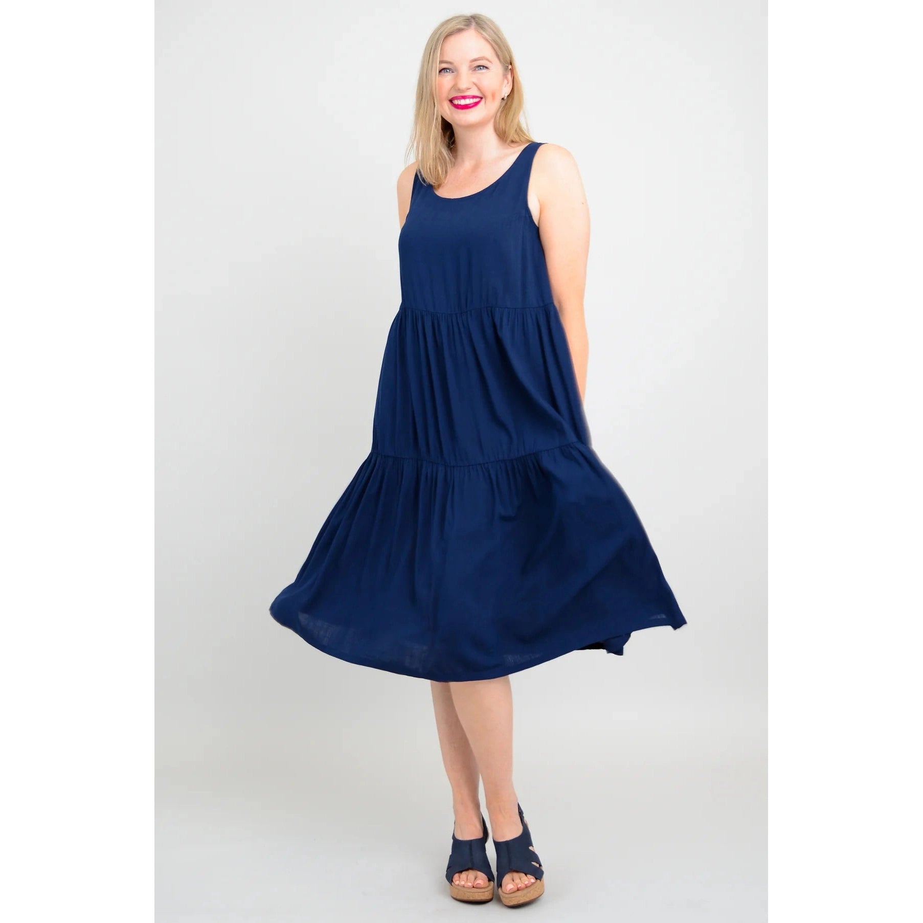 Blue Sky Juni Dress in Indigo shown on a model against a white background, from the front view. 