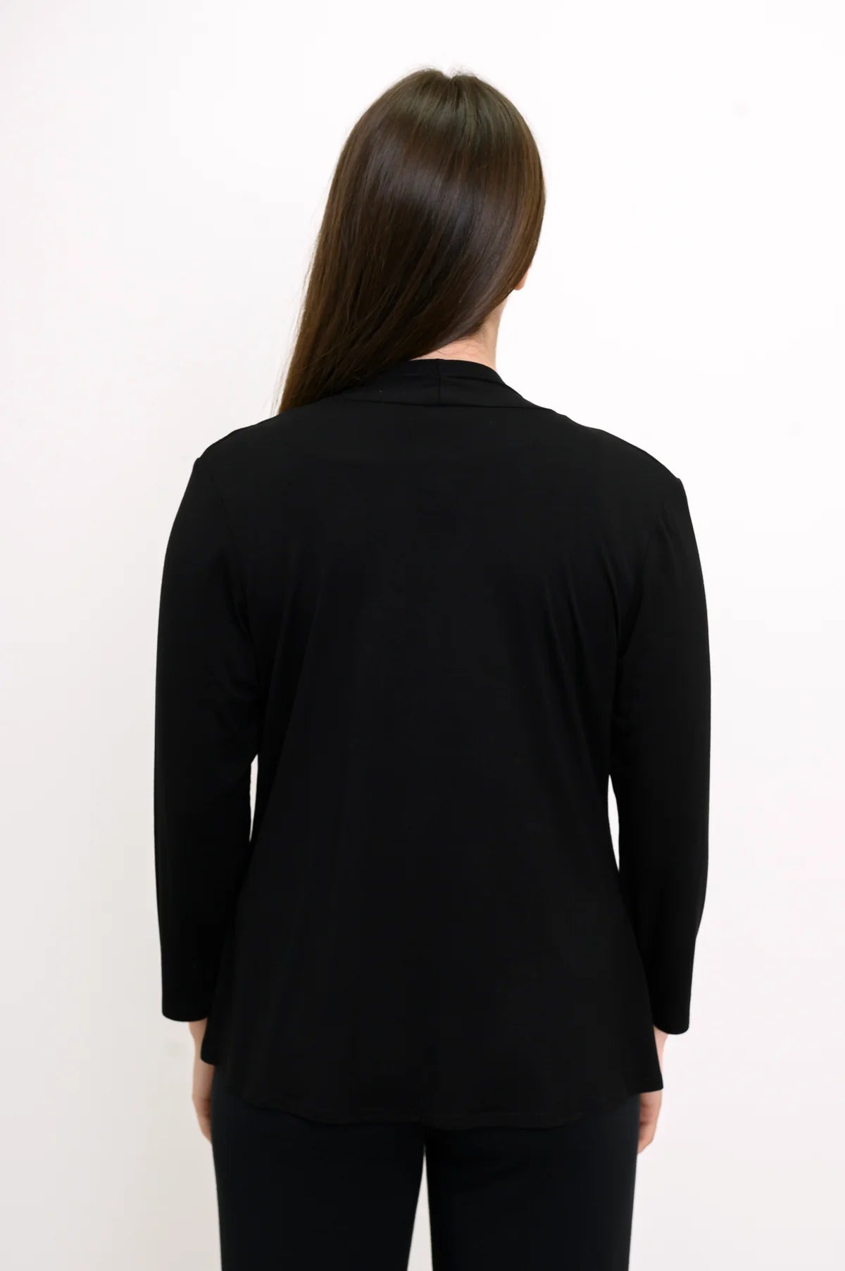 Blue Sky Kathy Jacket in Black shown on a model wearing it over a white tank with black pants against a white background, shown from the back. 