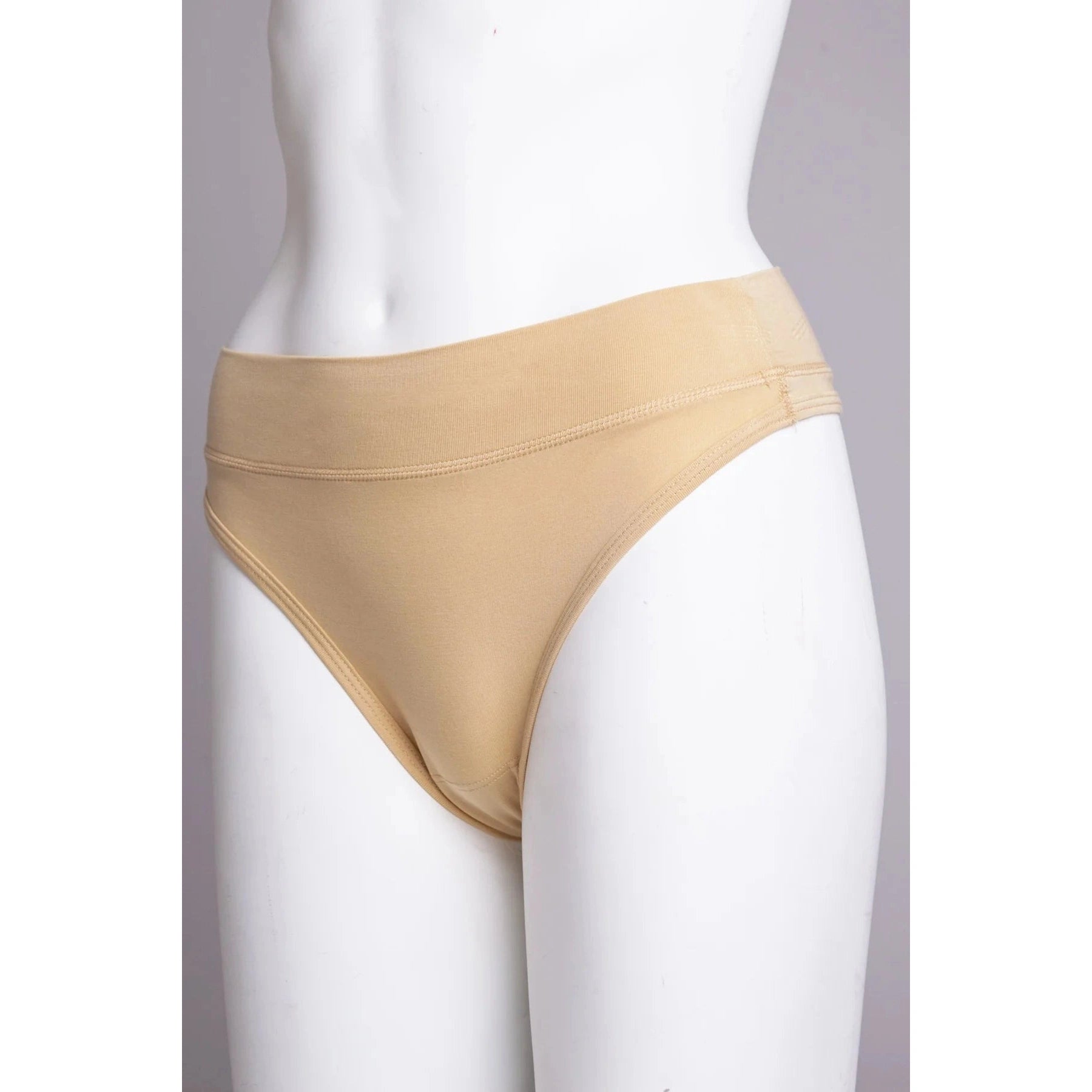 Blue Sky La Thong in Beige shown on a mannequin against a white background, showing the side view. 