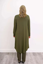 Blue Sky Priscilla Jacket in Khaki shown on a model wearing a white tank and khaki pants, standing against a white background, from the back view. 