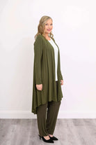 Blue Sky Priscilla Jacket in Khaki shown on a model wearing a white tank and khaki pants, standing against a white background, from the side view. 