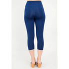 Blue Sky Riley Capris in Indigo shown on a model against a white background, from the back view. 