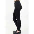 Blue Sky Riley Leggings in Black shown on a model against a white background, from the side view. 