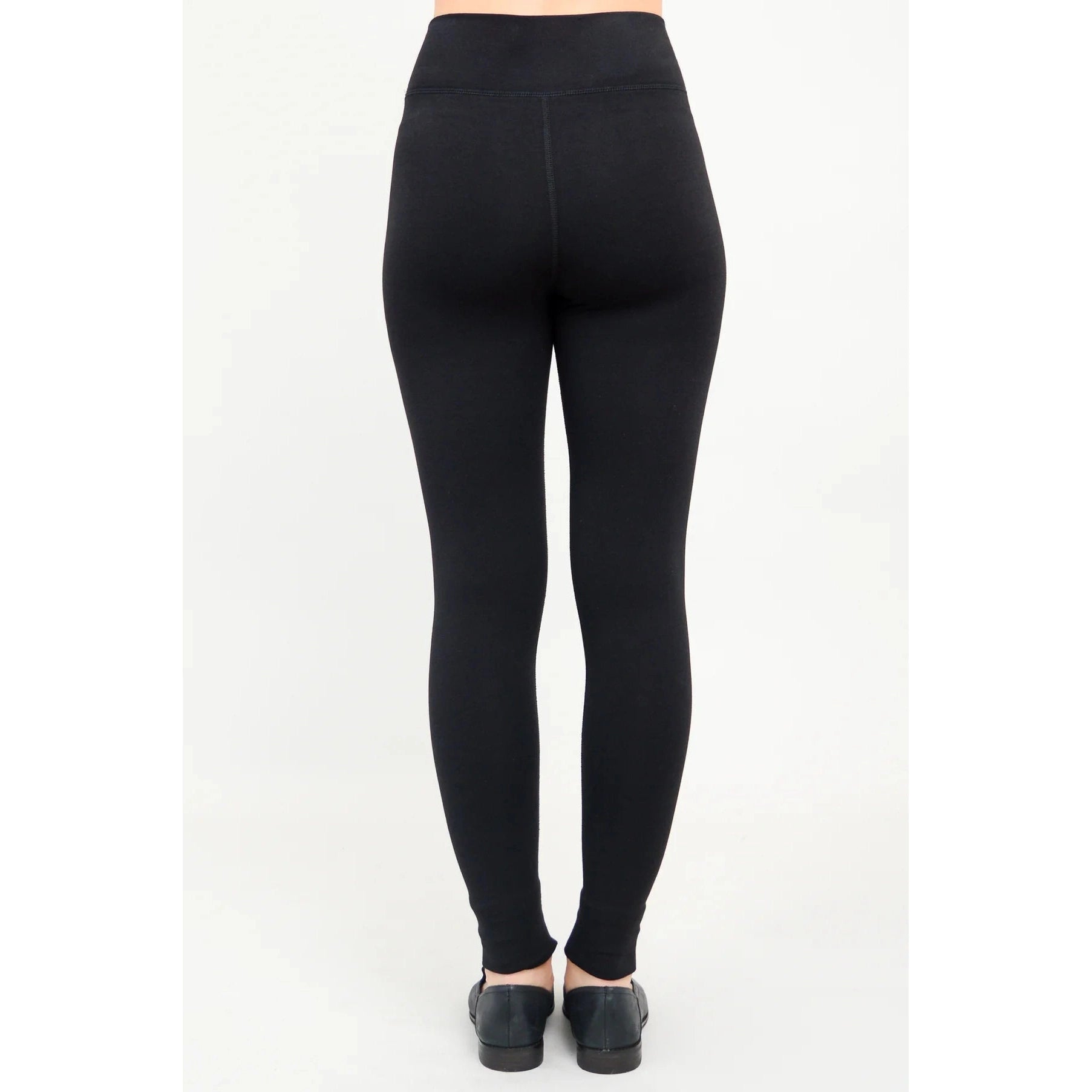Blue Sky Riley Leggings in Black shown on a model against a white background, from the back view. 