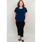 Blue Sky Tessa Tee in Indigo shown on a model wearing black leggings standing against a white background, from the front view. 