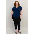 Blue Sky Tessa Tee in Indigo shown on a model wearing black leggings standing against a white background, from the front view. 