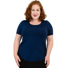 Blue Sky Tessa Tee in Indigo shown on a model wearing black leggings standing against a white background, from the front view. 