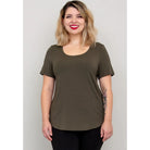 Blue Sky Tessa Tee in Khaki shown on a model wearing black leggings against a white background, from the front view. 