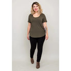 Blue Sky Tessa Tee in Khaki shown on a model wearing black leggings against a white background, from the front view. 