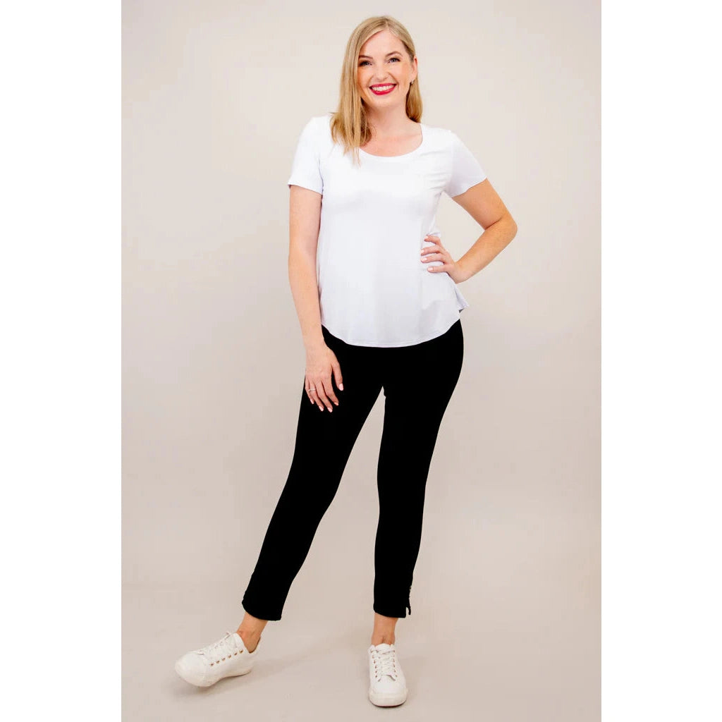 Blue Sky Tessa Tee in white shown on a model wearing black leggings, standing against a white background, from the front view. 