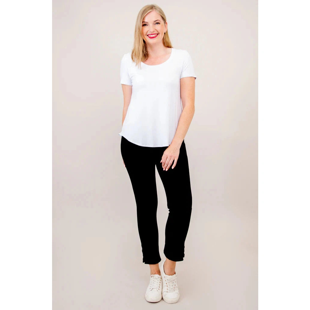 Blue Sky Tessa Tee in white shown on a model wearing black leggings, standing against a white background, from the front view. 