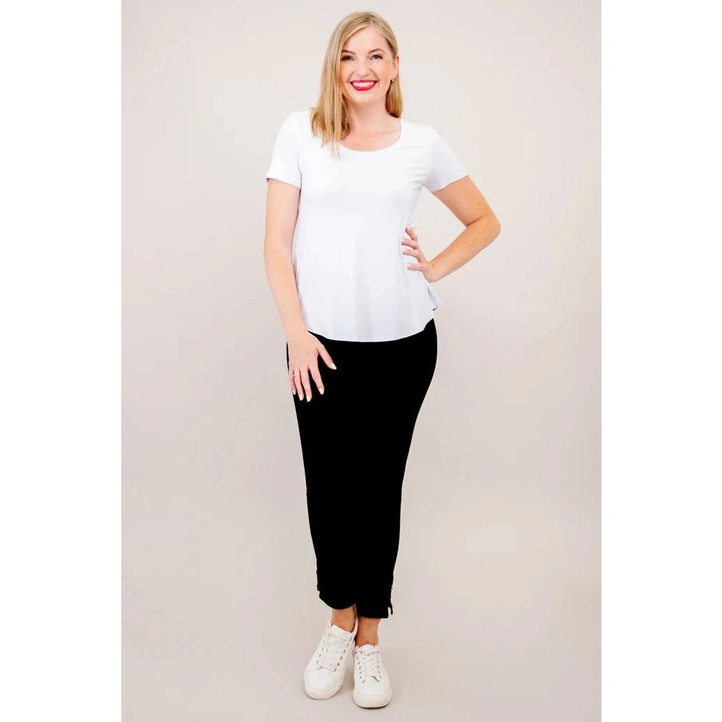 Blue Sky Tessa Tee in white shown on a model wearing black leggings, standing against a white background, from the front view. 