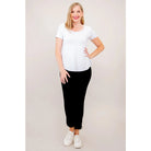 Blue Sky Tessa Tee in white shown on a model wearing black leggings, standing against a white background, from the front view. 