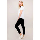 Blue Sky Tessa Tee in white shown on a model wearing black leggings, standing against a white background, from the side view. 
