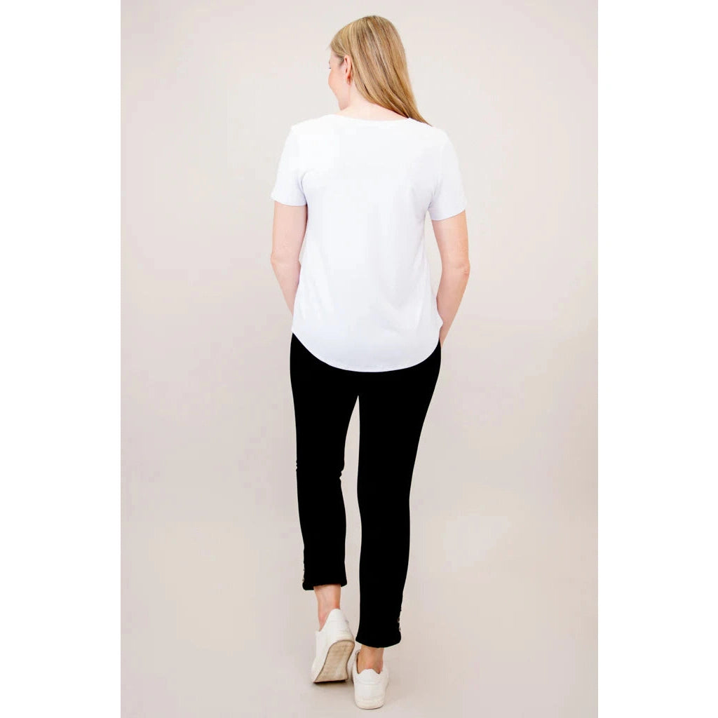 Blue Sky Tessa Tee in white shown on a model wearing black leggings, standing against a white background, from the back view. 