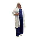 Woman wearing the Escape Getaway dress, a white button-down worn open over a navy tank and pants. 