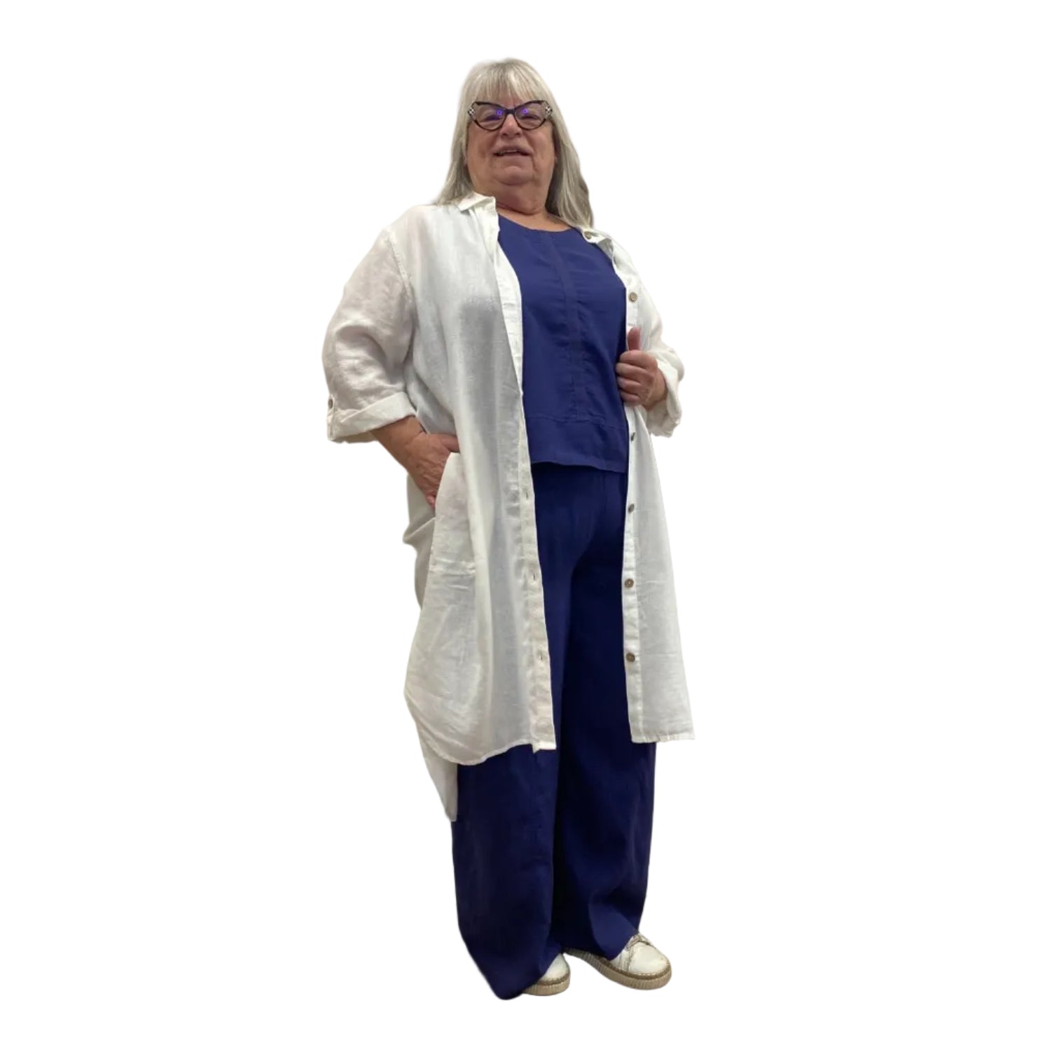 Woman wearing the Escape Getaway dress, a white button-down worn open over a navy tank and pants. 