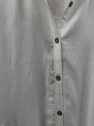Close-up of a light white fabric with button details