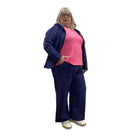 Woman wearing the Escape Crew Tank in Cosmo pink with a navy hoodie overtop and paired with navy pants against a white background. 
