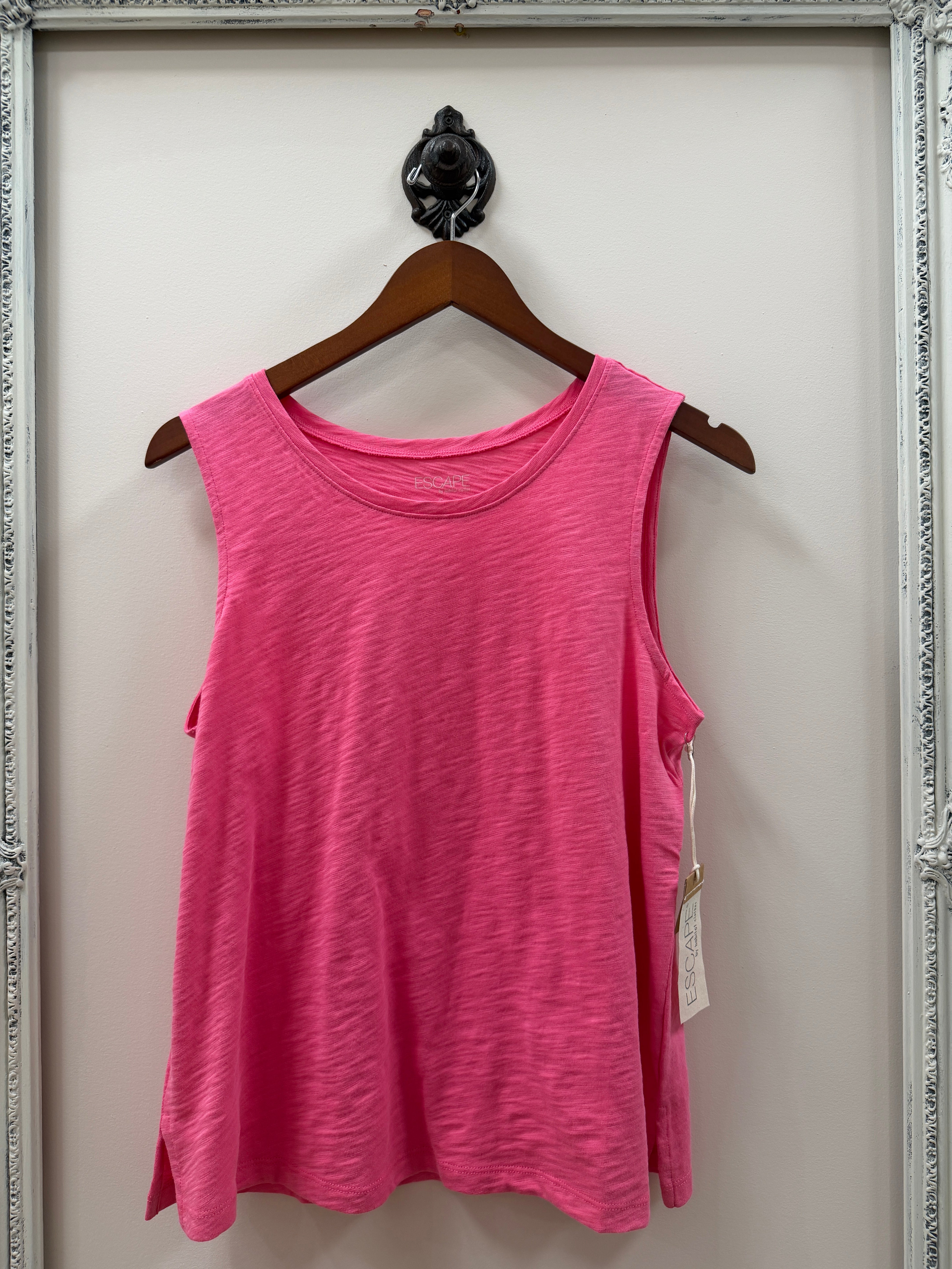 Pink tank on a hanger with a white background