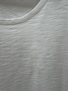 Close-up of a textured white t-shirt. 