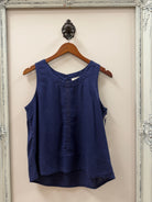 Escape Getaway Tank in Navy on hanger on wall with frame. 