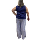 Woman wearing the Escape Harborside Flood Pants in blue and white stripe. 