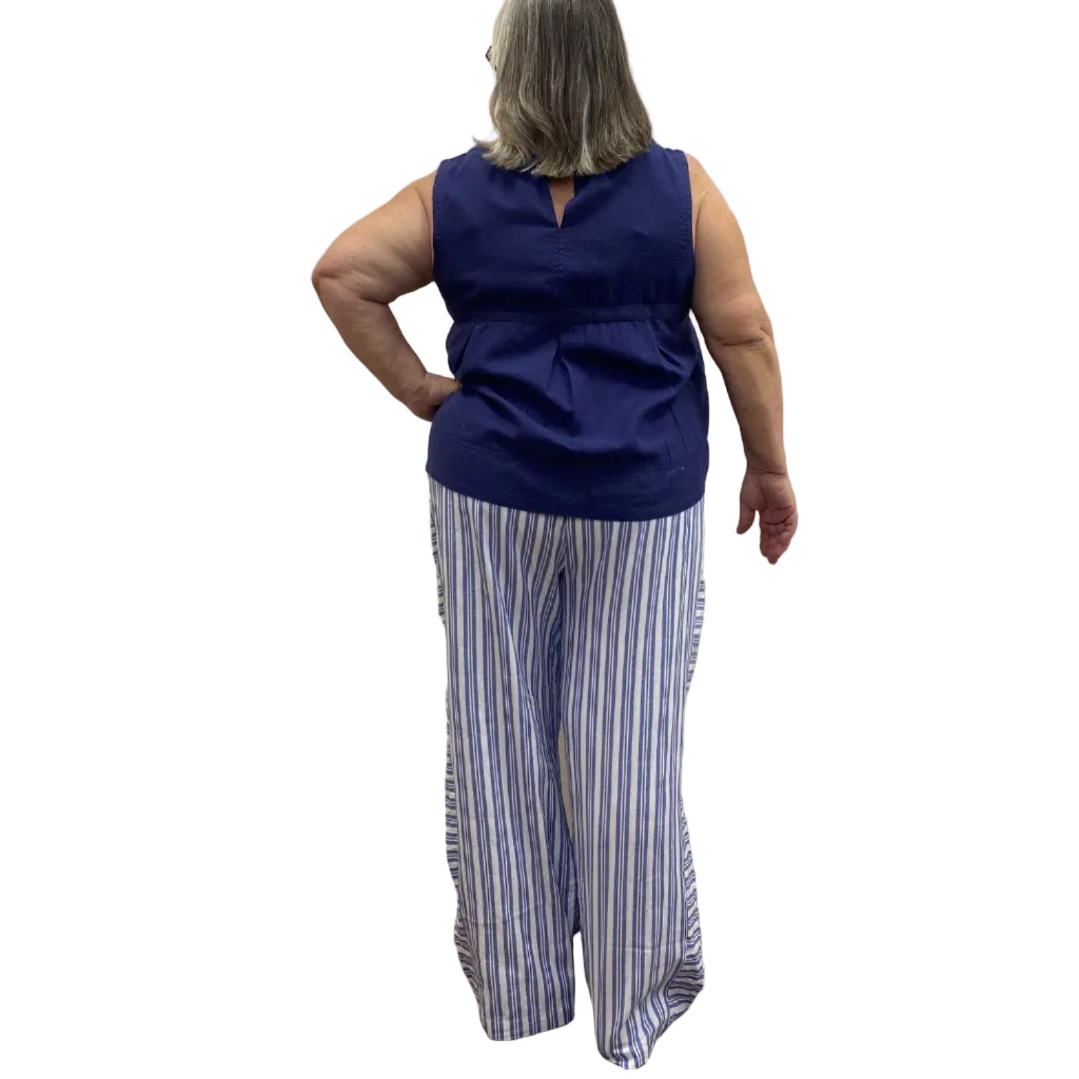 Woman wearing the Escape Harborside Flood Pants in blue and white stripe. 