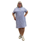 Woman wearing the Escape Marina Shirt Dress with blue and white stripes against a white background. 