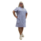 Woman wearing the Escape Marina Shirt Dress with blue and white stripes against a white background. 
