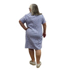 Woman wearing the Escape Marina Shirt Dress with blue and white stripes against a white background. 