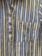 Close-up of a blue and white striped shirt with button details