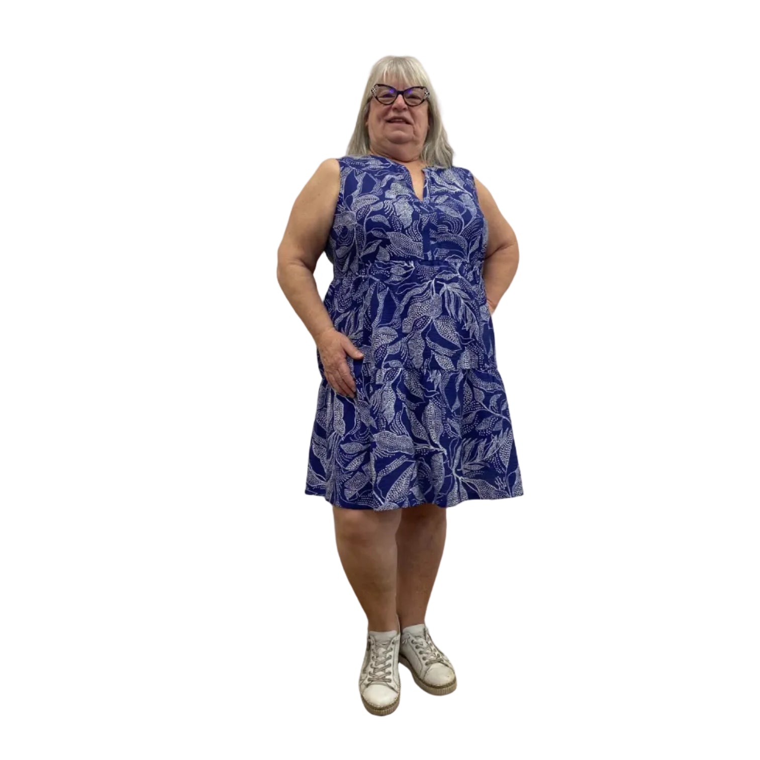 Woman wearing a Escape Paradise Dress in navy and white floral pattern against a white background. 