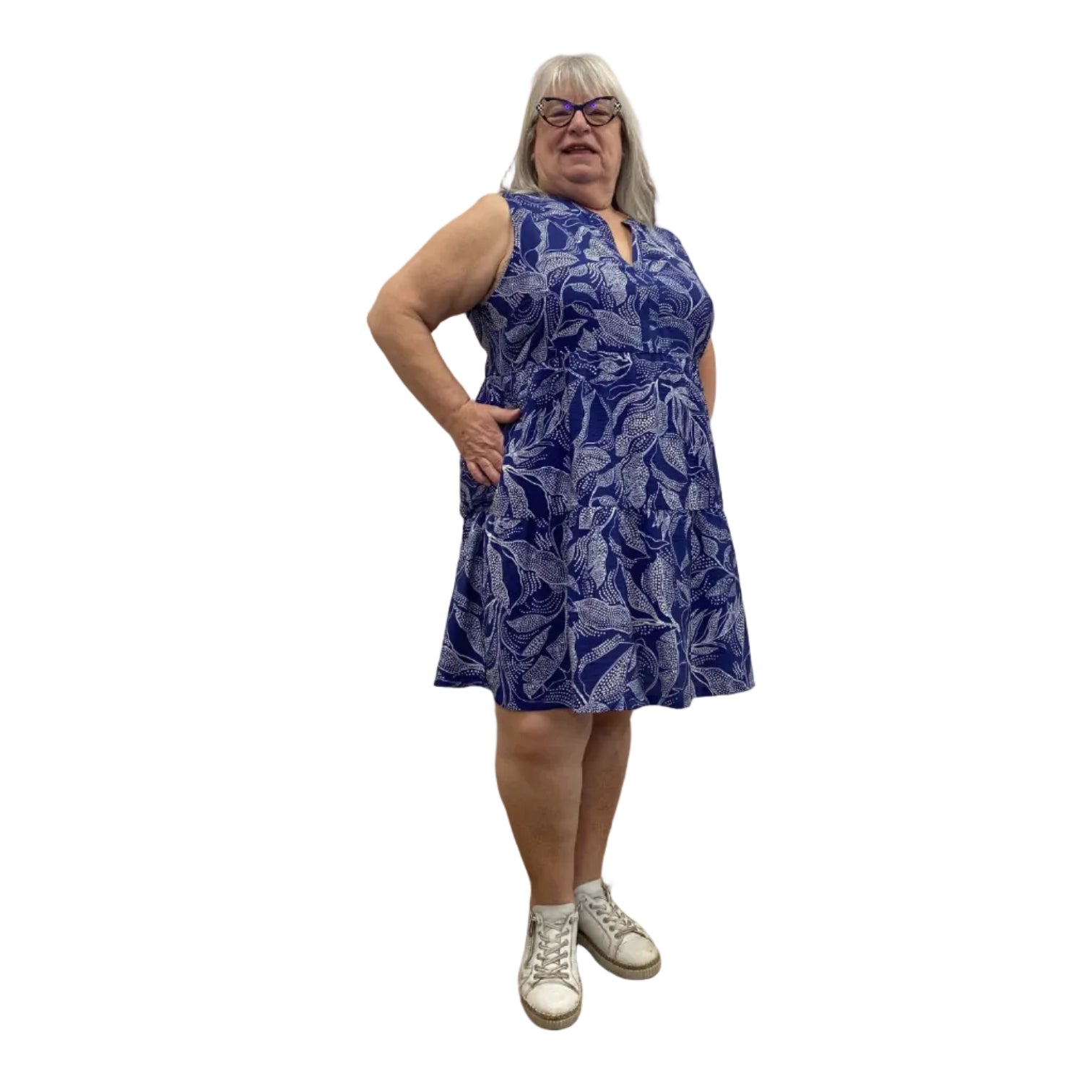 Woman wearing a Escape Paradise Dress in navy and white floral pattern against a white background. 